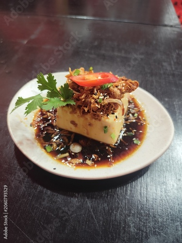 Seasoned tofu, cut into cubes and topped with fried shallots and coriander, is a traditional local dish from Phuket Province, Thailand.