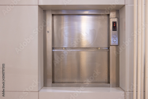 фотографія dumbwaiter, Modern food elevator with stainless steel door and control panel