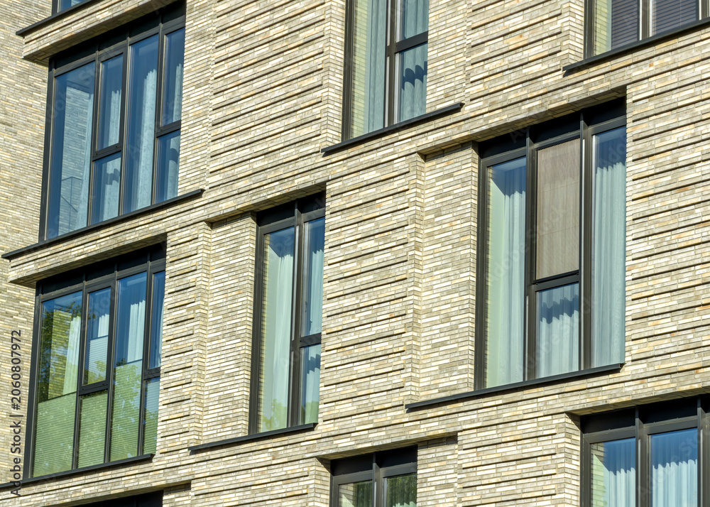 Obraz premium contemporary apartment building facade with large windows.
