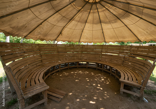 Wooden benches under a canvas roof