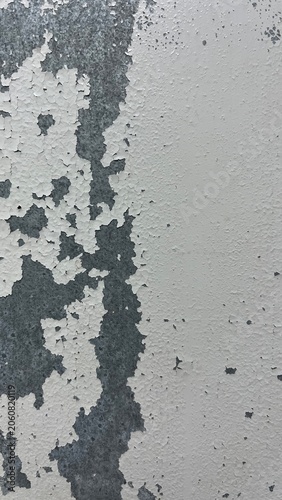 Peeling White Paint Texture on Weathered Metal Surface, 16:9 Format. White paint peeling off background.