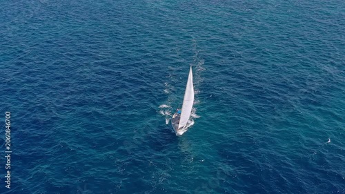 Aerial view of white sailboats in close formation during Mediterranean regatta event