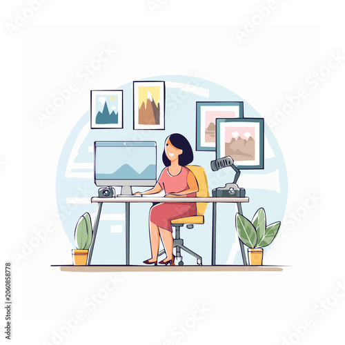 Woman working at a desk with computer and artwork