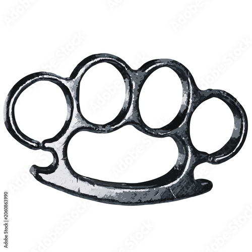 a dark metal brass knuckle (knuckle duster) with four finger holes, featuring a worn, scratched surface with a heavy and solid appearance.
