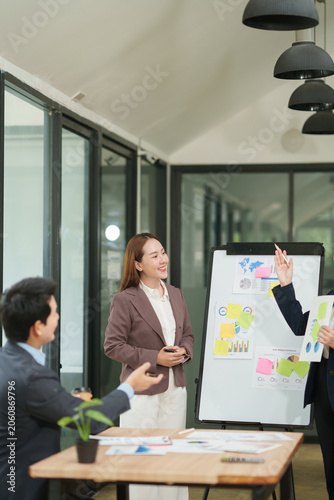 Professional Businesswoman Presenting Marketing Report and Charts to the Team