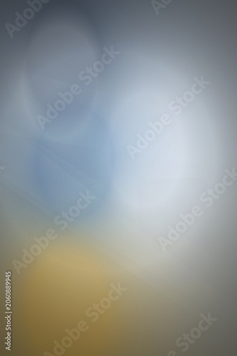 Abstract blurred bokeh background with blue, grey and yellow tones