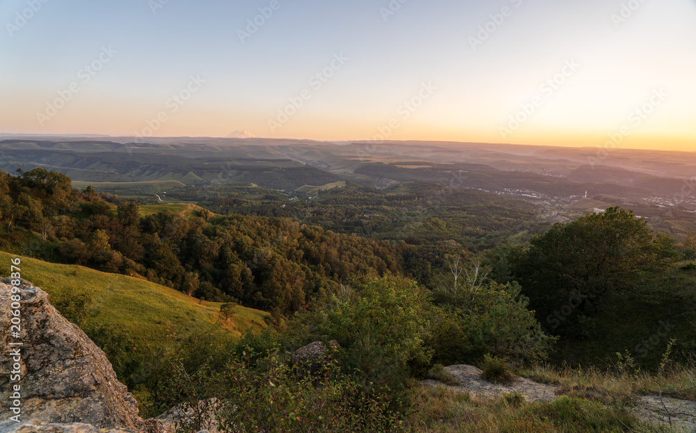Fototapeta premium View of the mountains and Kislovodsk from the observation decks of the Kislovodsk Park. Evening sunset over the mountains of Kislovodsk.