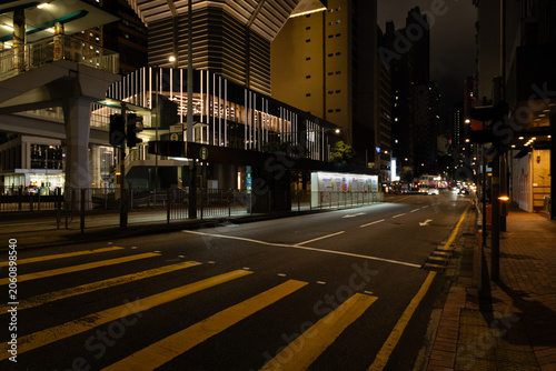 Tableau sur toile An empty multi-lane road at night outside Admiralty MTR station in Hong Kong, wi