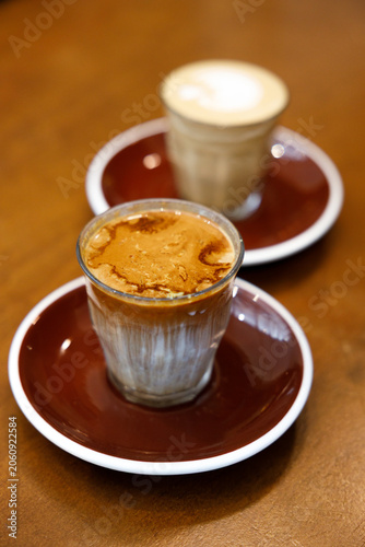 Glass of milk latte coffee on a wooden table.