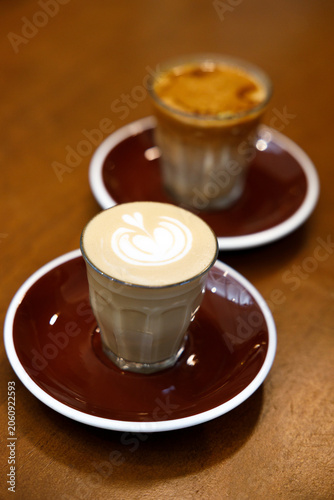 Glass of milk latte coffee on a wooden table.