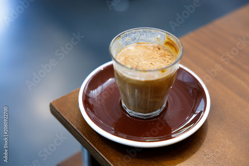 Glass of milk latte coffee on a wooden table.
