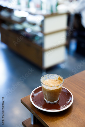 Glass of milk latte coffee on a wooden table.