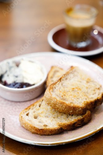 Toast sourdough bread with butter spread on a wooden table.