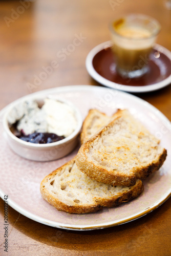 Toast sourdough bread with butter spread on a wooden table.