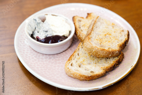 Toast sourdough bread with butter spread on a wooden table.