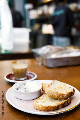 Toast sourdough bread with butter spread on a wooden table.