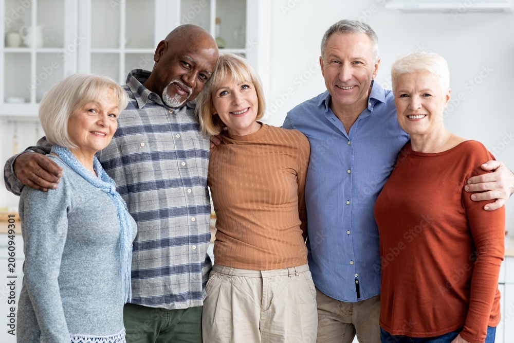 Obraz premium Happy Multiracial Senior Group Of Four Adults Smiling Together In Home Environment, Enjoying Each Other's Company And Sharing Moments Of Joy, Indoor Setting Reflecting Community Concept.