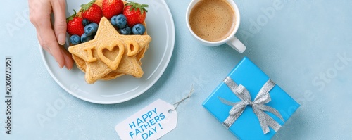 Pancakes topped with strawberries and blueberries served with coffee and  blue gift box