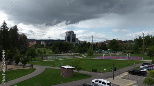 Aerial of community park and residential area in Coeur dAlene Idaho under cloudy skies featuring sports courts and green spaces
