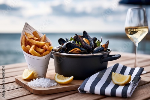 Steaming mussels with french fries and white wine overlooking the sea