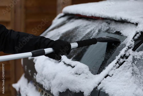 Clearing and remove snow from windshield, Scraping ice. Winter season car window cleaning