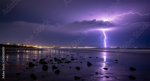 Dramatic lightning strike over coastal town at night