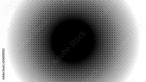 An optical illusion. Concentric rings. The black hole effect. Black and white geometric circular pattern. The gradient vignette is a tunnel.