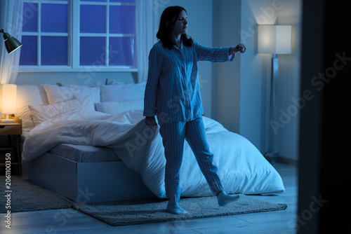 Young woman sleepwalking in...