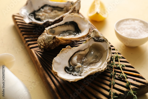 Fresh raw oysters on wooden...