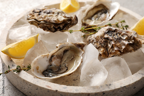 Fresh raw oysters on ice wi...