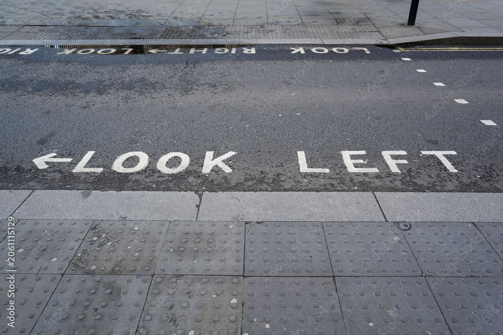 Fototapeta premium Look Left road safety marking at a pedestrian crossing in London