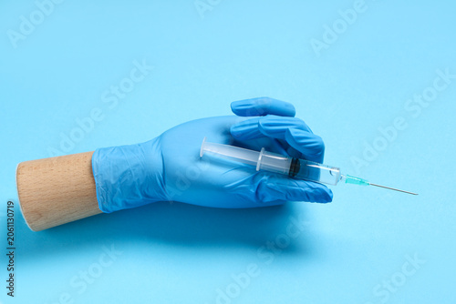 Wooden hand in medical glov...