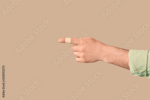Male hand with taped finger...
