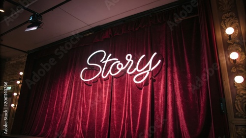 Vintage Stage Curtain with Neon Story Sign and Warm Lighting for Theater, Performance, or Event Decor