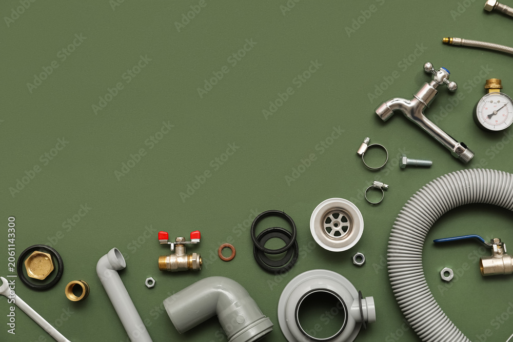Fototapeta premium Set of plumbers items on green background