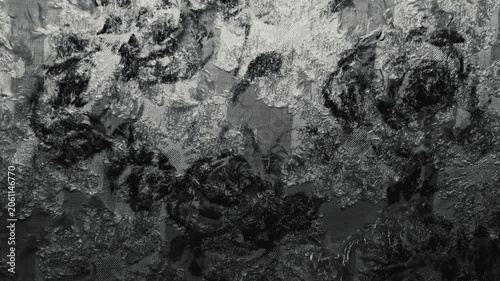 textured black and white floral jacquard fabric ripples gently under dramatic cinematic chiaroscuro studio lighting