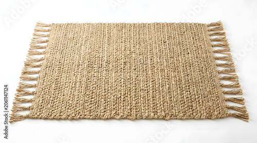 A rectangular natural fiber woven rug with fringes on a white background, viewed from an elevated angle.