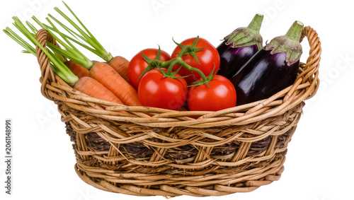 Fotografie Wicker basket filled with fresh carrots tomatoes, and eggplants