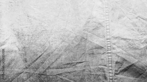 textured monochrome fabric ripples gently as subtle light shifts across raw cotton weave stitching details