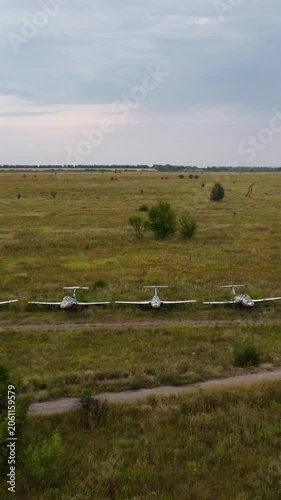 Abandoned trainer jet aircrafts Aero L-29 parked in line on neglected airfield