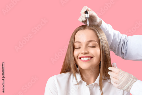 Cosmetologist applying seru...