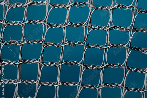 Photos Close up of twisted metal mesh against blue background