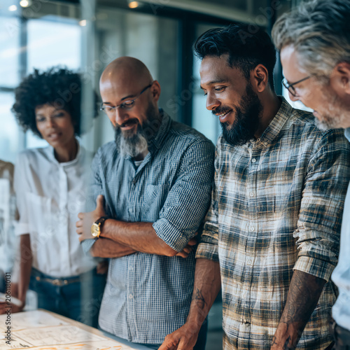 Diverse international business team brainstorming in modern conference room, teamwork, leadership, innovation, startup culture, authentic people, realistic corporate photography, natural lighting, cop
