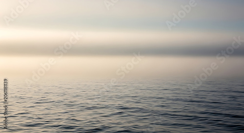 Calm ocean water surface at sunset.