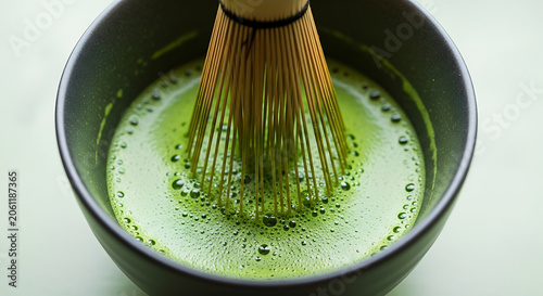 Matcha green tea whisk in bowl.