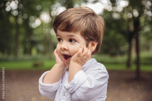 Toddler making surprised face in park