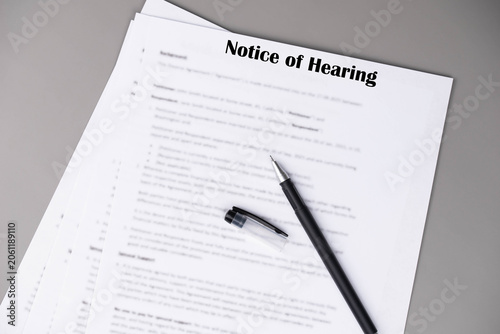 Notice of Hearing document lying on a table, concept of court scheduling, legal notice, and probate proceedings.