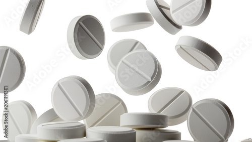 Fotografie Many white round pills with score line falling, isolated on transparent backgrou