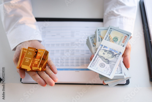 Fotografie Businessman buying or selling gold, investing against inflation and currency depreciation