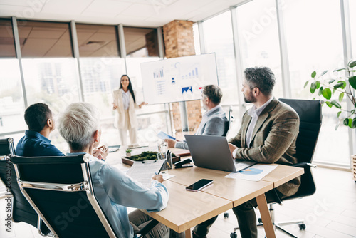 Photos Team members collaborating during a presentation meeting in a modern office work